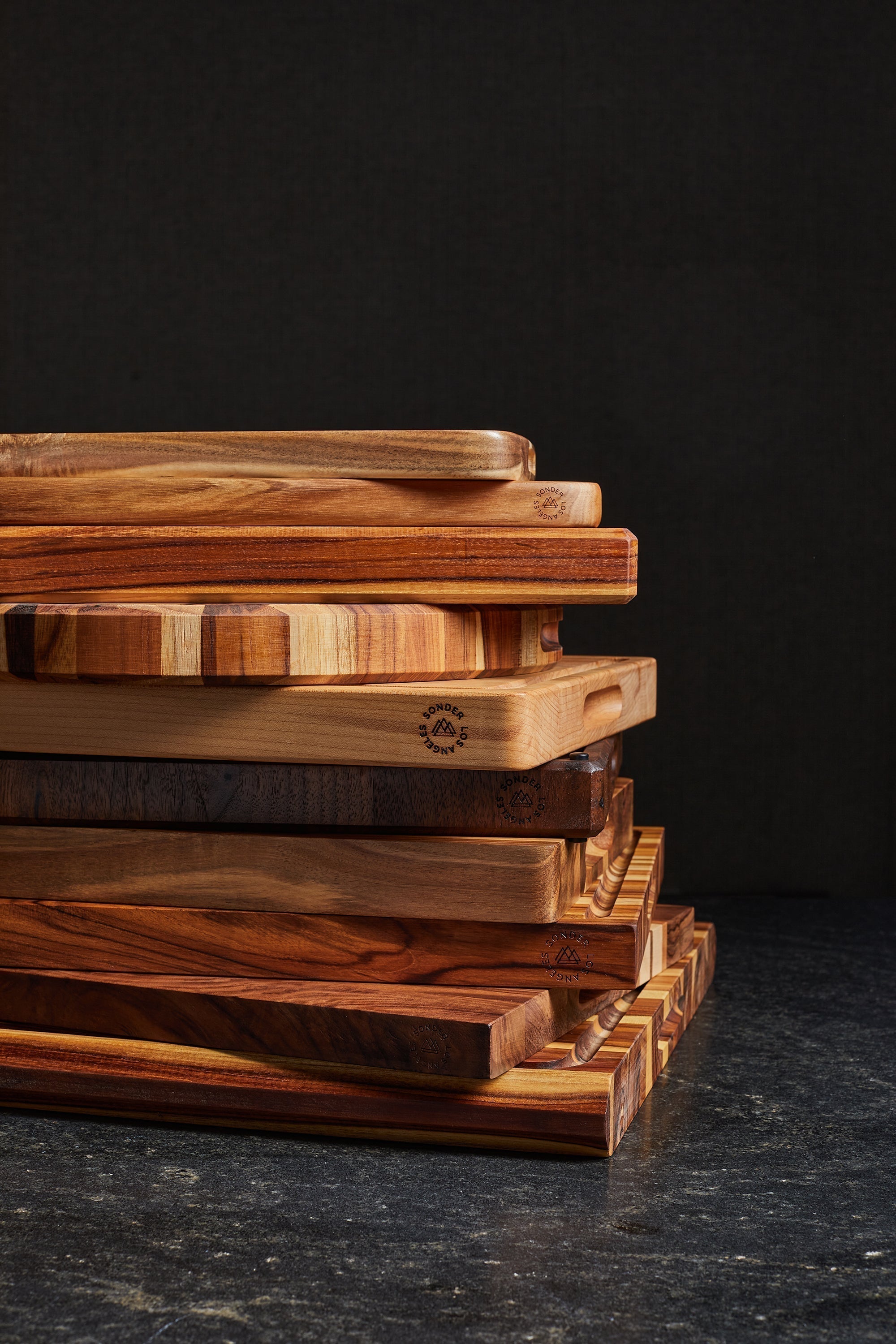 A stack of SonderLA cutting boards on a black backdrop