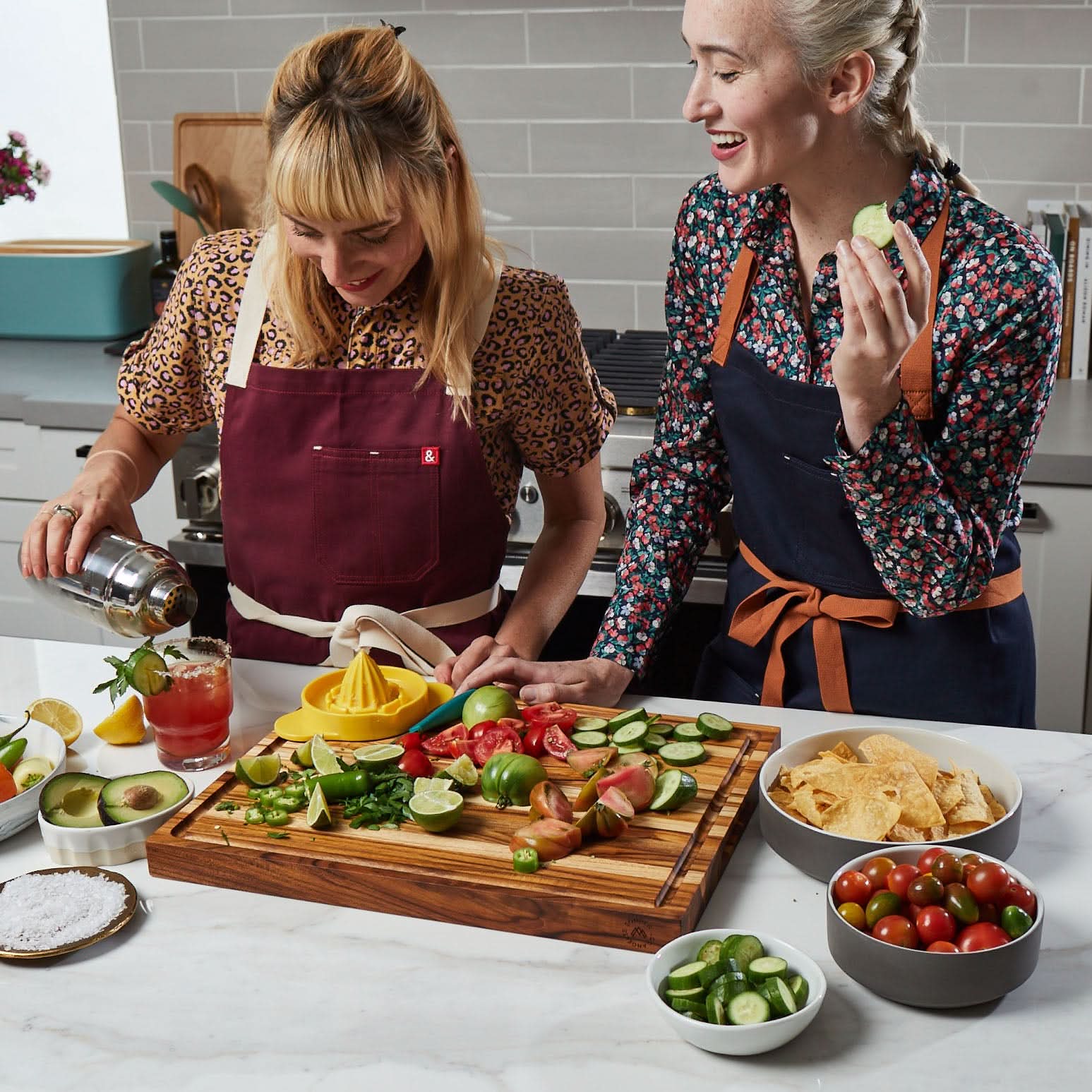 Ladies in kitchen laughing and making margaritas with Laurel Teak Wood Cutting Board by Sonder Los Angeles