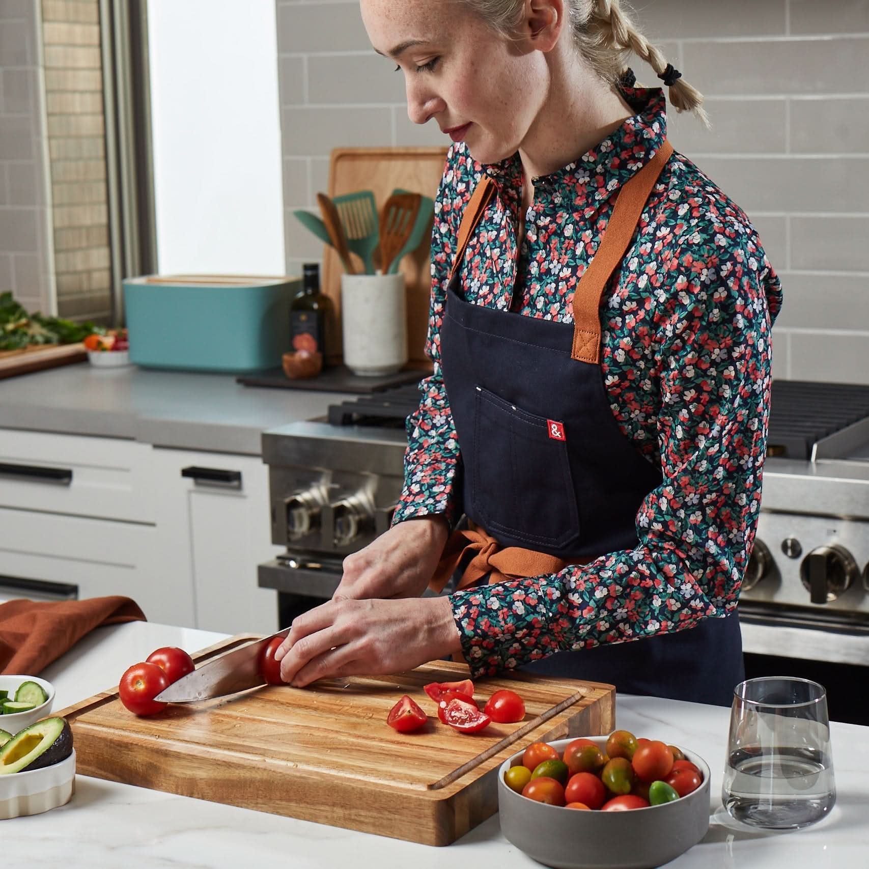 Sonder Los Angeles, Girl Cutting Tomatoes in kitchen with Winsome Acacia Board