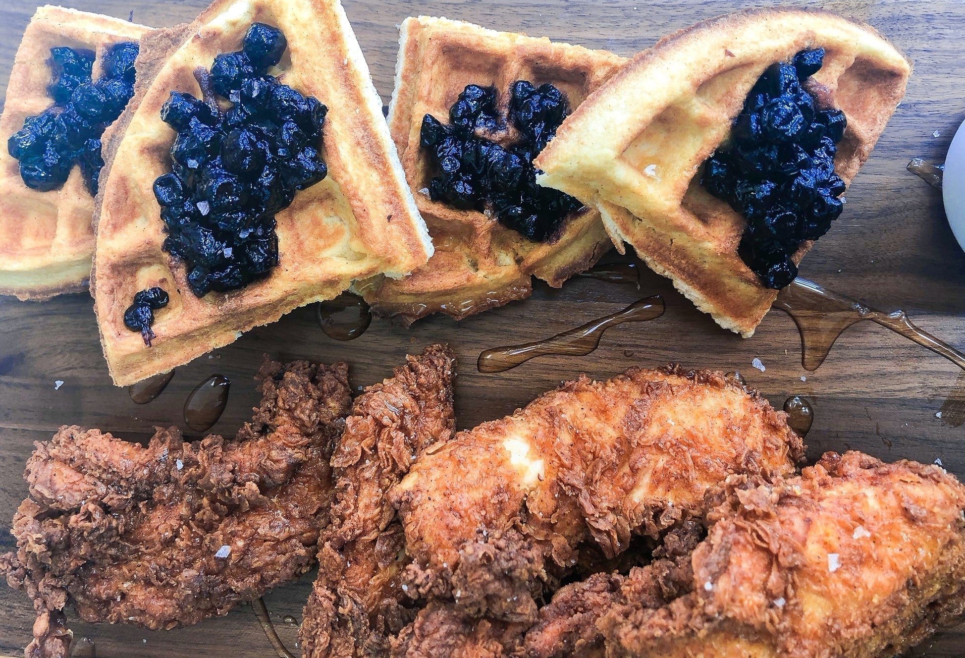 Spiced fried chicken and waffles with blueberry lime jam served on a Sonder LA walnut cutting board
