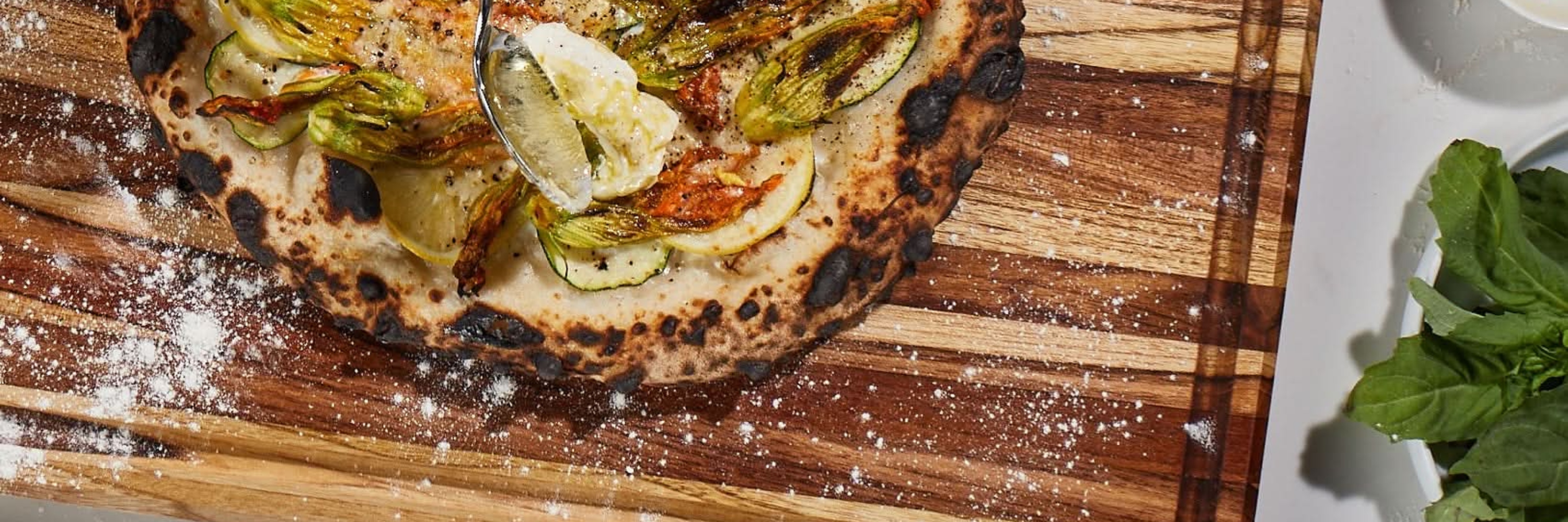 a pizza on a Sonder LA BBQ board