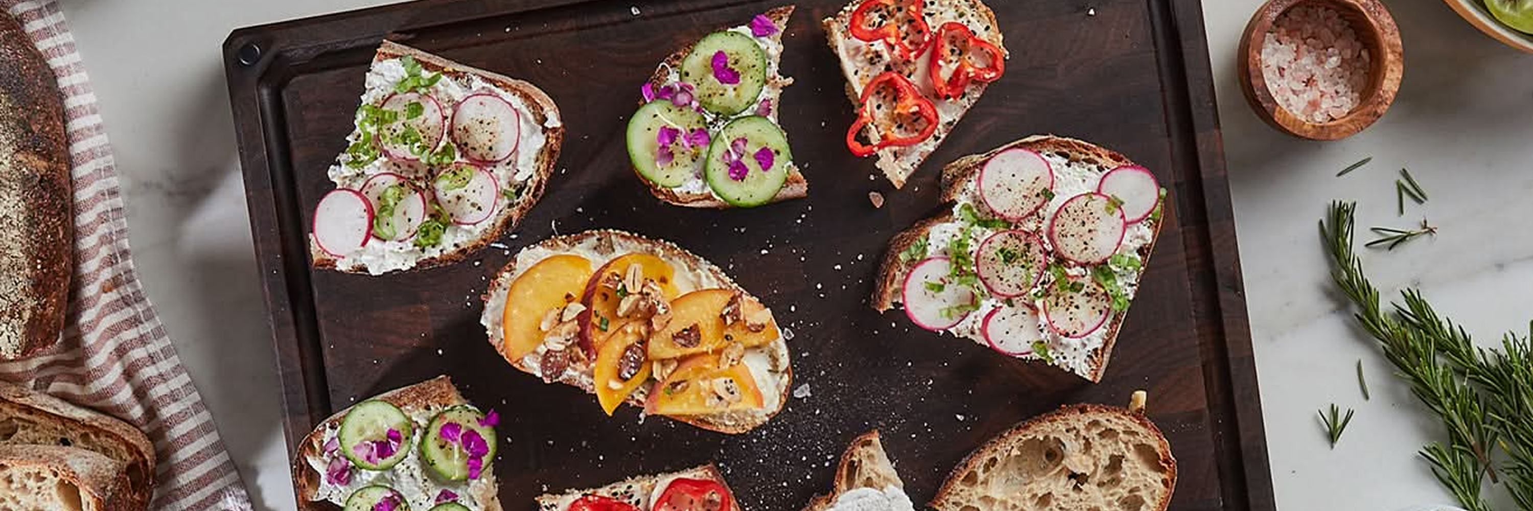 an array of fancy toasts on a Sonder LA end grain cutting board