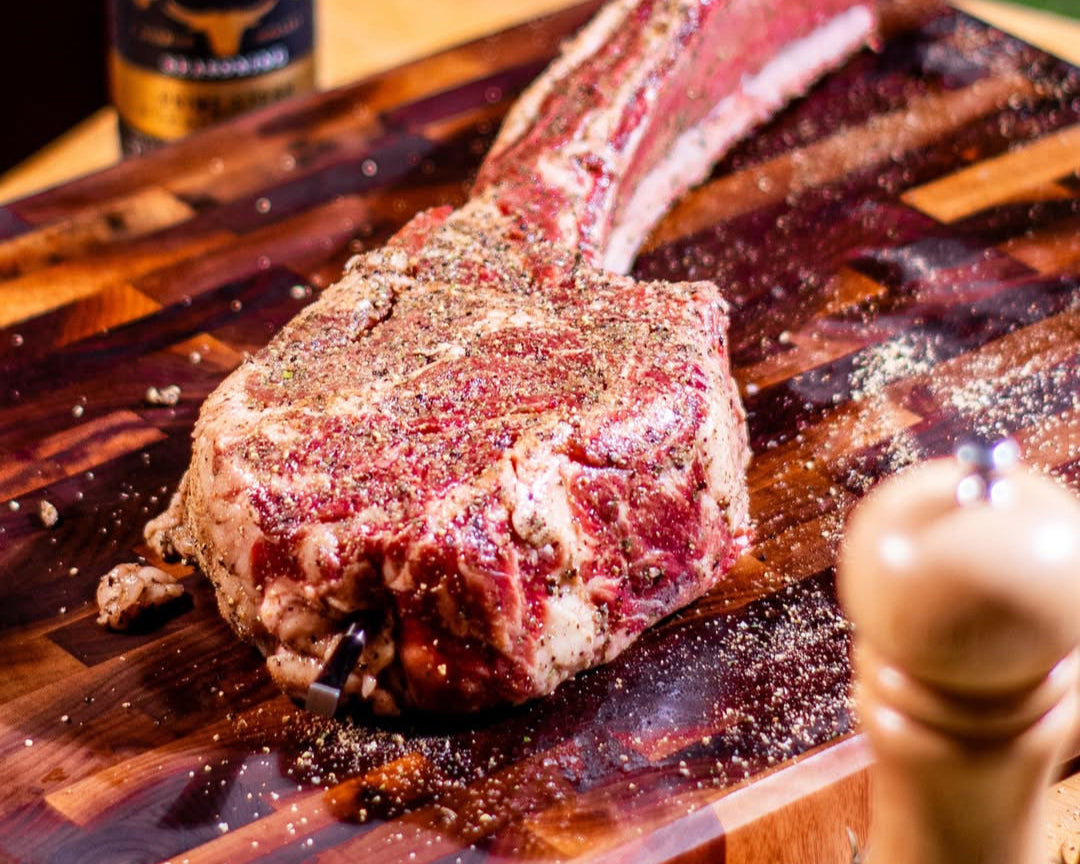 Tomahawk steak on a Sonder Los Angeles Welton American Black Walnut cutting board.