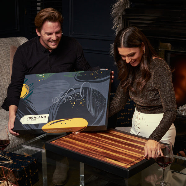 Couple opening Sonder Los Angeles Highland Teak Wood Cutting Board Gift Box