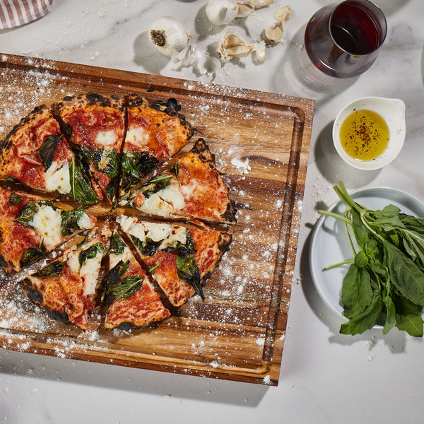 Sonder Los Angeles Large Laurel Teak Wood Cutting Board with Freshly Made Pizza